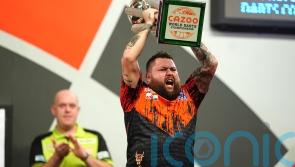 Michael Smith throws nine-darter en route to winning maiden World Championship