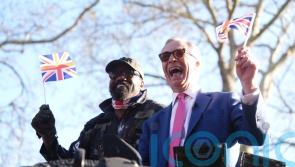 Derek Chisora arrives at media event in army tank with Nigel Farage