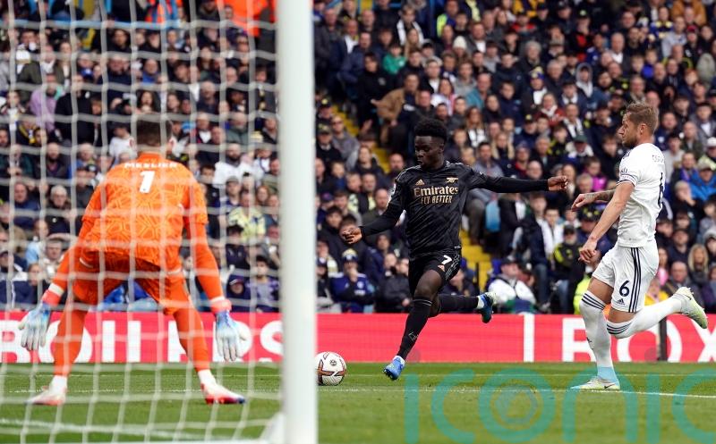 Bukayo Saka fires Arsenal to win as league leaders survive late scare at Leeds